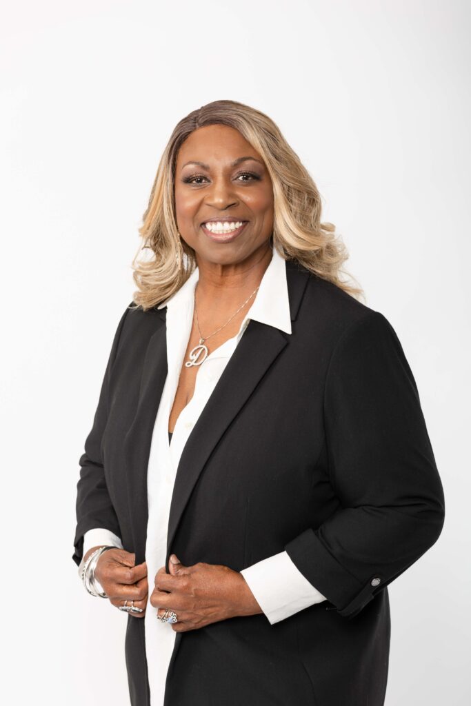 Studio portraits of Denise Carter in a black blazer and white blouse.