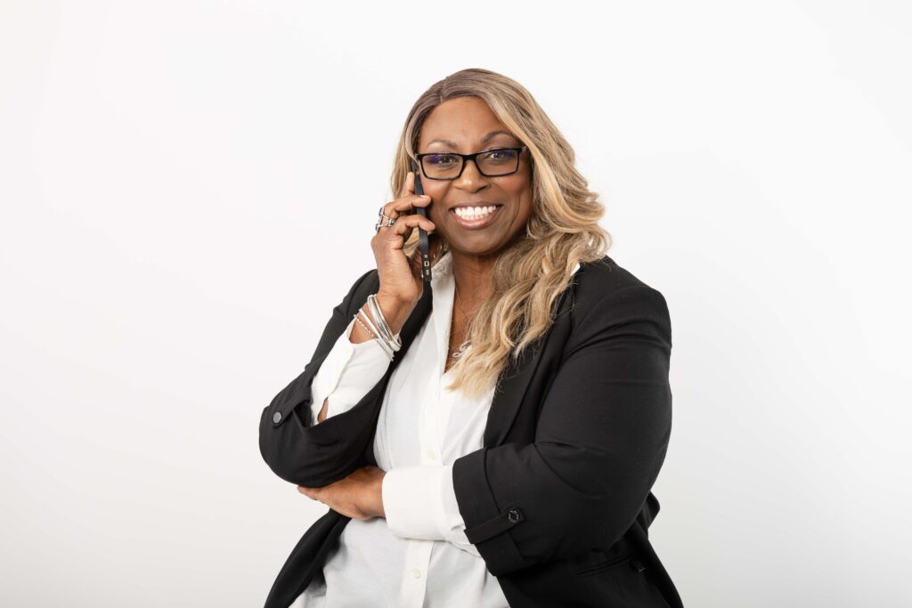 Studio portraits of Denise Carter in a black blazer and white blouse.