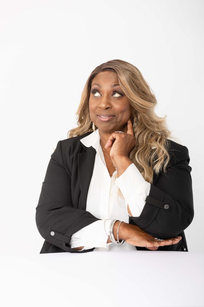 Studio portraits of Denise Carter in a black blazer and white blouse.