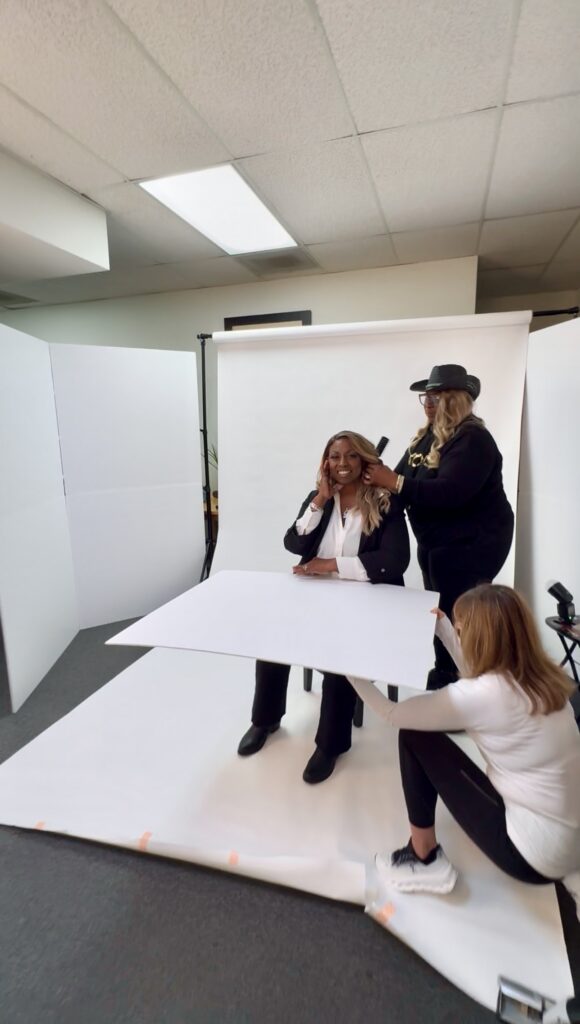 Behind-the-scenes images of Denise Carter’s brand photoshoot with studio lighting and white backdrop setup in an office space.