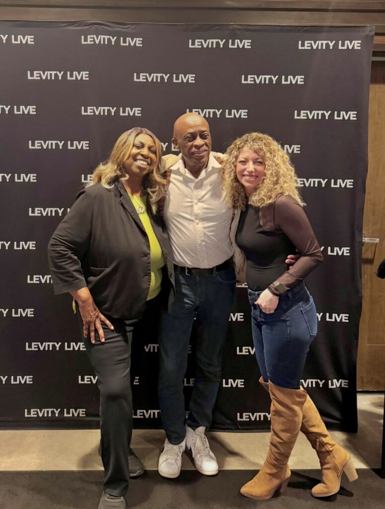 Denise Carter posing with her husband Wills and photographer at Levity Live in Oxnard, California.